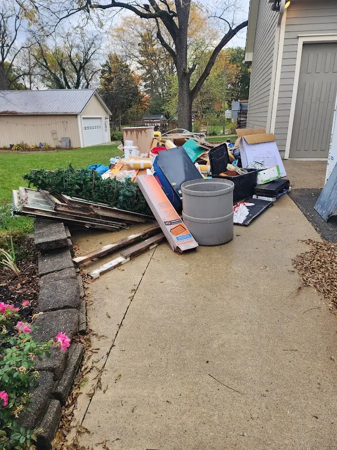 Dumpster being loaded with debris for Roofing Dumpster Rental in Owatonna
